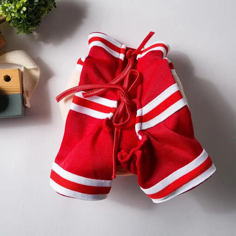 Dog baskJ costume featuring a vibrant red design with white stripes, perfect for pet dress-up and Halloween.